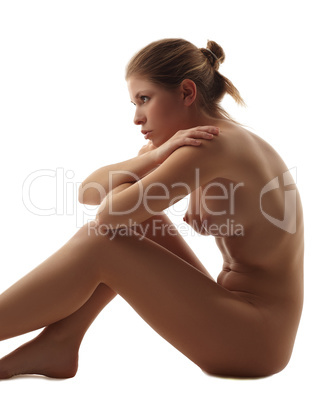 Studio shot of pretty nude girl sitting