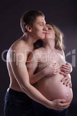 Concept - tenderness of loving pair awaiting baby
