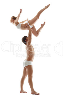 Studio photo of strong man holding graceful girl