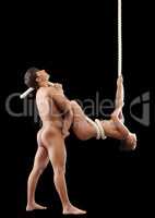 Enchanted nude man cuddles sexy girl hangs on rope