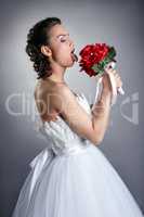 Pretty bride fooling around with bouquet