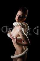 Alluring girl with perfect body wrapped in rope