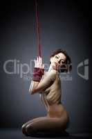 Submissive woman posing with her hands tied