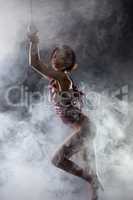 Image of naked tied woman posing in smoke