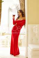 Elegant brunette with glass of wine in restaurant