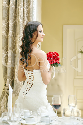 Smiling pretty bride while relaxing in restaurant