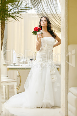 Image of elegant bride posing in restaurant