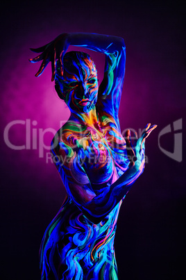 Fantasy woman with body art glowing in neon light