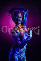 Fantasy woman with body art glowing in neon light