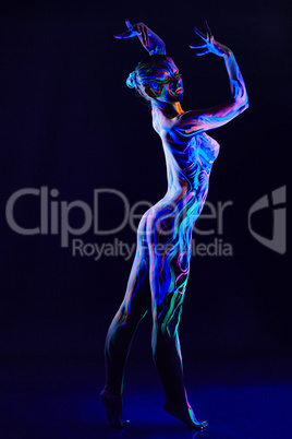 Graceful nude dancer with glowing body art