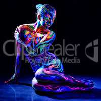 Charming nude girl with luminescent body art