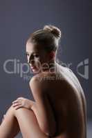 Thoughtful nude woman posing in studio