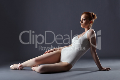 Pretty red-haired ballerina in shimmering leotard
