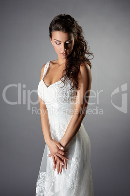 Thoughtful bride in elegant wedding dress