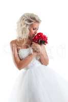 Romantic blond bride cuddles bouquet