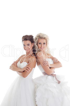 Nice girlfriends posing in elegant wedding dresses