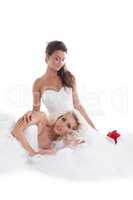 Tired bride lying on knees of her bridesmaid