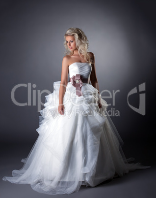 Majestic bride posing in lush wedding dress