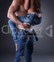 Passionate embrace of sexy models in jeans