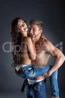 Happy topless lovers posing in trendy jeans