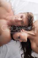 Top view of handsome young couple in bed