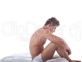 Concept of impotence. Upset man sitting in bed