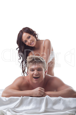 Grinning girl doing massage to her lover