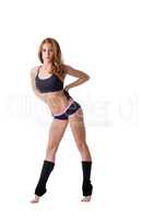 Pretty redhead female athlete posing on tiptoe