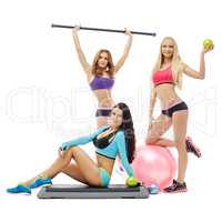 Charming young women posing with sports equipment