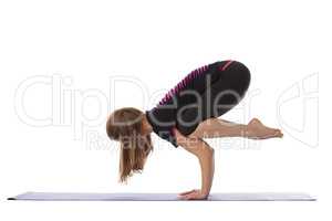 Studio shot of flexible woman doing yoga handstand