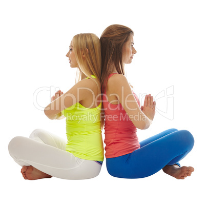 Athletic girlfriends posing sitting back-to-back