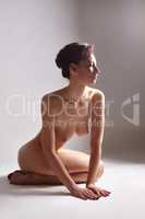 Image of relaxed nude woman posing cross-legged