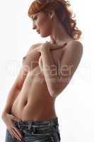 Fascinating red-haired woman posing naked to waist