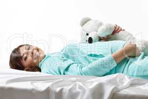 Merry expectant mother posing in embrace with toy