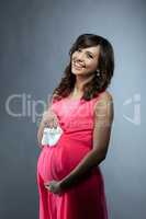 Studio photo of happy pregnant woman posing
