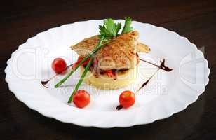 Serving of mashed potato with tasty baked fish