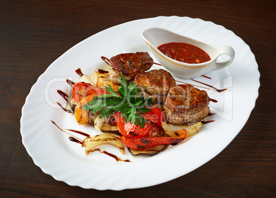 Meat cutlets with roasted vegetables and sauce