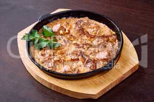 Appetizing meat baked with cheese and walnuts