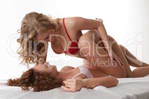 Studio shot of sexy girls doing foreplay