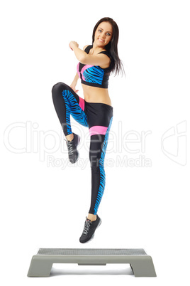 Cheerful young girl jumping on stepper