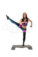 Vigorous athletic girl exercising on stepper