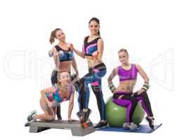 Pretty young girls posing with sports equipment
