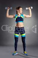 Image of cute girl exercising with dumbbells