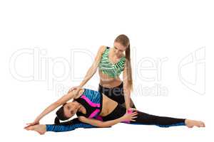 Girl helps her friend doing stretching exercise