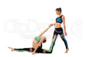 Sporty girls doing stretching exercise in pair