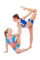 Lovely female gymnasts warming up in pair