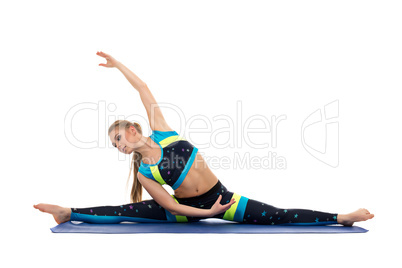 Pretty female gymnast doing splits and bending
