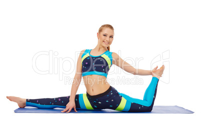 Smiling flexible girl doing gymnastic split