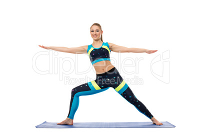 Pretty girl engaged in aerobics on mat