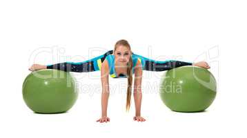Amazing girl stretched out on two fitness balls